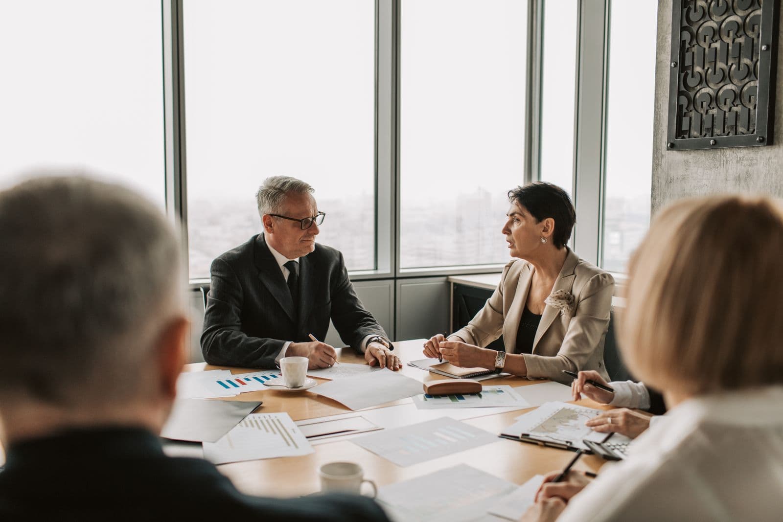 Professionals in a boardroom discussion